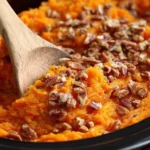 Crockpot Sweet Potato Casserole with pecan topping and creamy filling