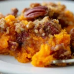 Easy Sweet Potato Casserole with pecan topping in a white baking dish
