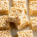Stack of gooey Family Favorite Rice Krispie Treats on marble countertop