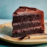 Gluten-free chocolate cake with chocolate frosting on a cake stand