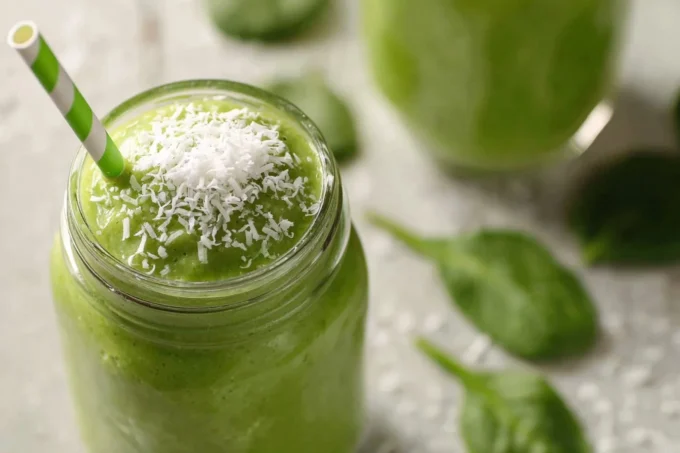 Tall frothy Matcha Green Tea Smoothie with light condensation.