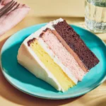 Three-layer Neapolitan cake with strawberry, chocolate, and vanilla layers