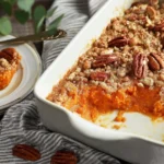 Paula Deen’s Sweet Potato Casserole with pecan topping in a white baking dish