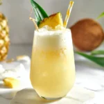 Pineapple Colada Mocktail in a chilled hurricane glass with pineapple wedge