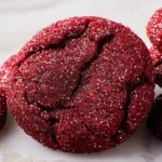 Sparkly red velvet cookies with a sugared finish on a plate