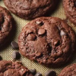 Freshly baked Triple Chocolate Chip Crinkle Cookies with melted chocolate chips