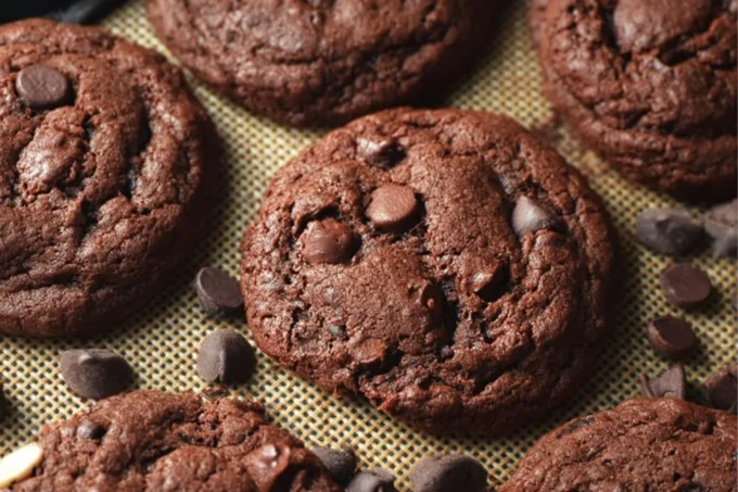 Freshly baked Triple Chocolate Chip Crinkle Cookies with melted chocolate chips