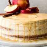 Delicious Bourbon Apple Cider Cake topped with caramel drizzle and apple slices.