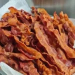 Crispy Baked Bacon on a baking sheet ready to serve