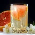 Sparkling grapefruit cocktail served in a glass with garnishes