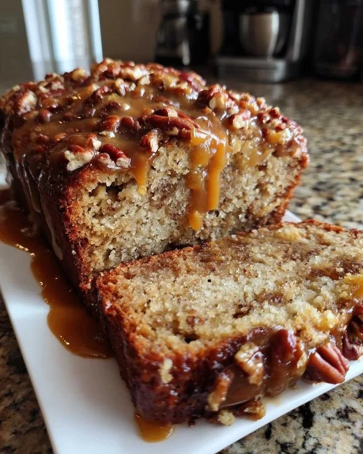 Freshly baked banana bread sliced and served on a wooden board