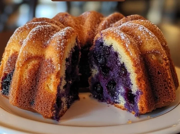 Delicious blueberry bundt cake topped with glaze and fresh berries