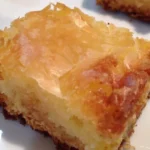 Deliciously rich ooey gooey butter cake served on a plate.