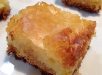 Deliciously rich ooey gooey butter cake served on a plate.
