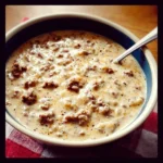 Pioneer Woman-style sausage gravy served with biscuits.