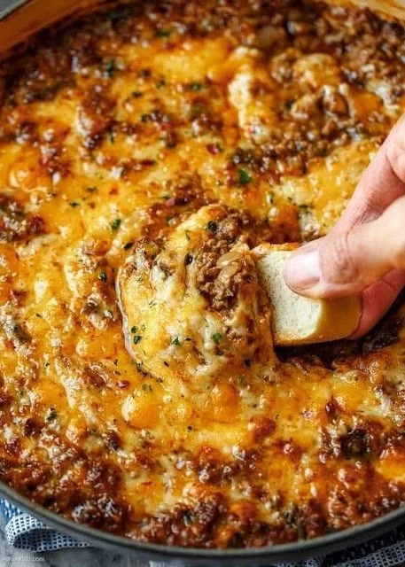 Cheesy beef dip served with fresh vegetables and tortilla chips