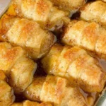 Freshly baked cinnamon apple dumplings topped with caramel sauce