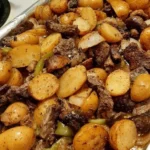 Juicy NY Strip Steak served with baby golden potatoes on a plate