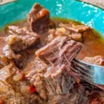 Delicious crockpot pepper steak served with green peppers and rice.