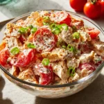 Colorful and fresh tomato salad served in a bowl with herbs.
