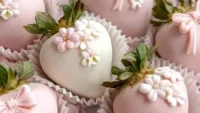Delicious chocolate covered strawberries drizzled with white chocolate on a platter