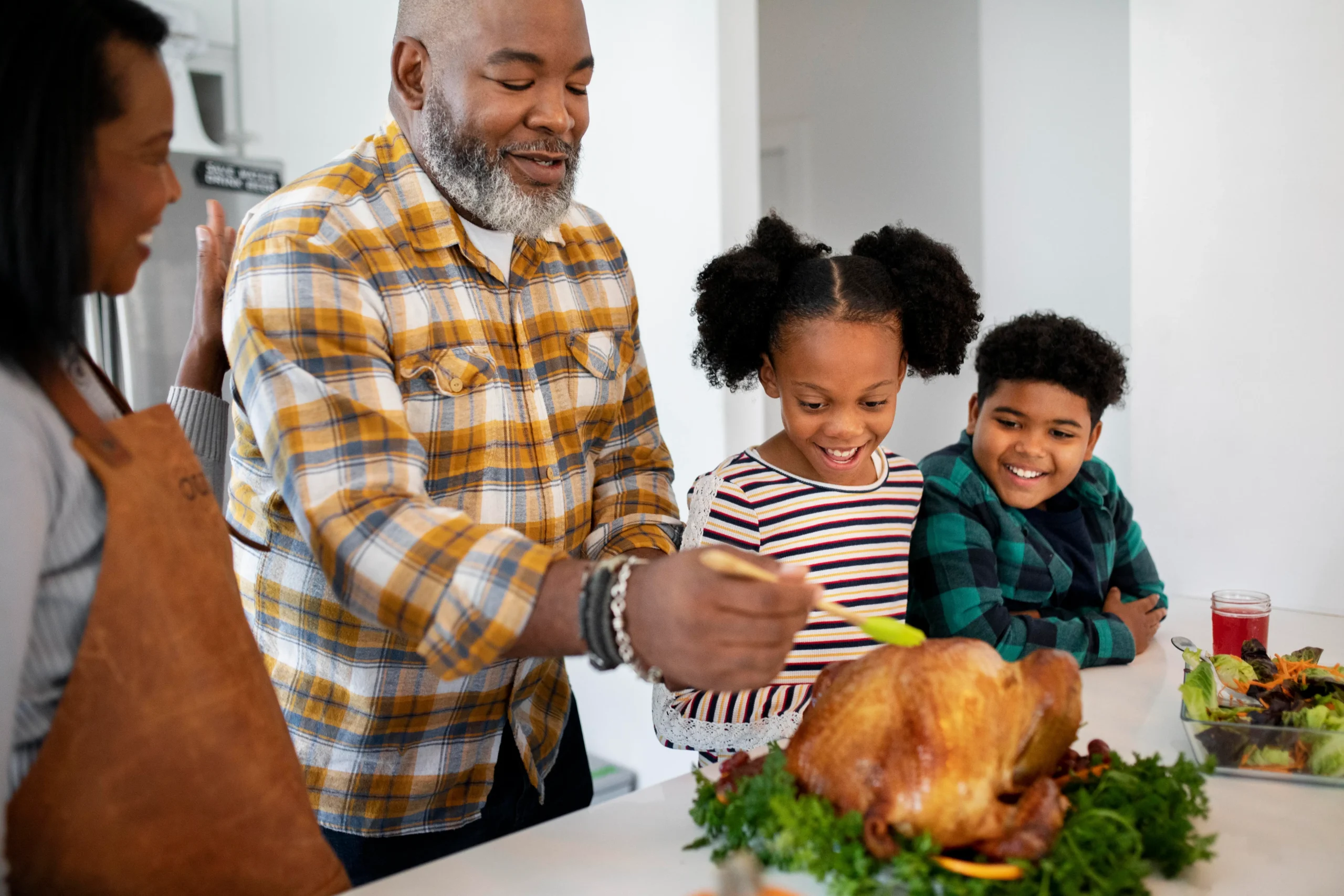 A family preparing food together in a warm home kitchen